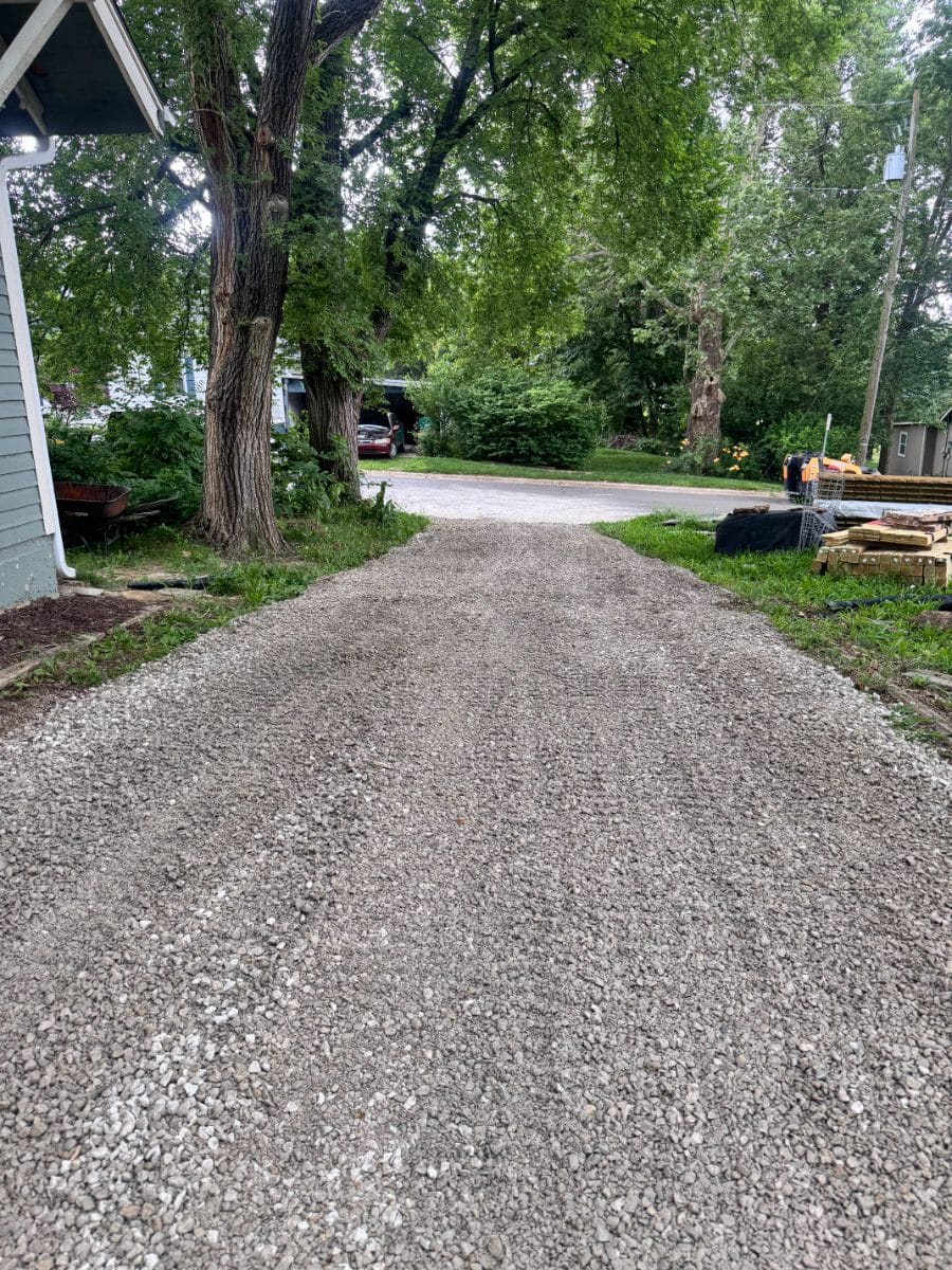 Wide freshly graveled driveway after regrading